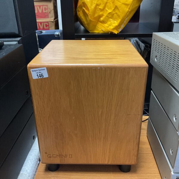 Side view of a vintage Gemini II subwoofer in a wooden cabinet.