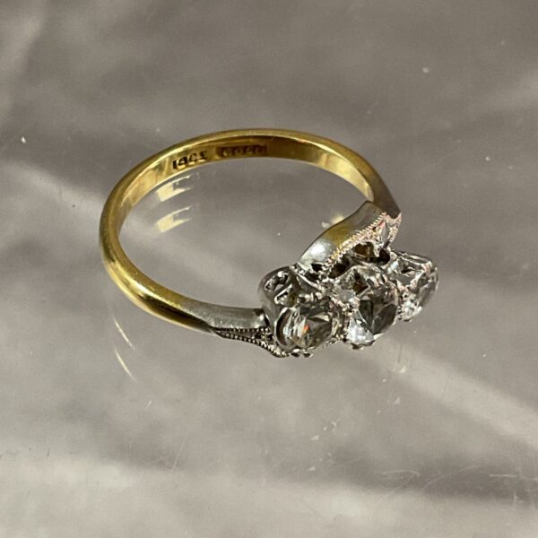 Elegant 18ct gold trilogy ring with three diamonds.