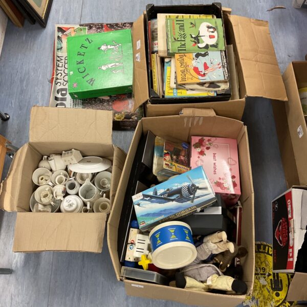 Vintage toy and book lot with colourful covers and various items.