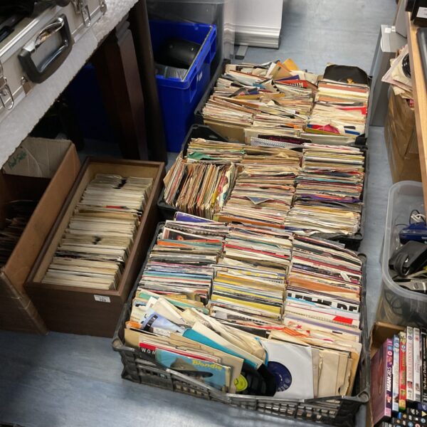 Large lot of vintage 7 inch vinyl records in crates.