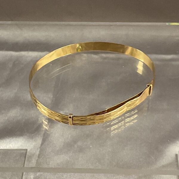 Close-up of a delicate 9ct gold bracelet.