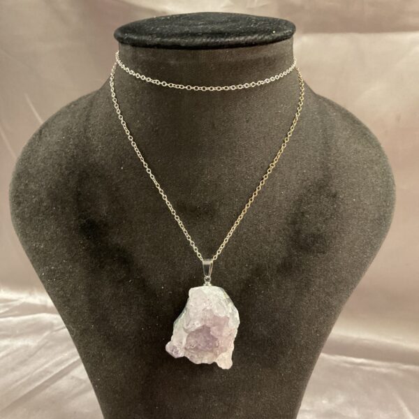 Stunning amethyst crystal necklace with a silver chain.