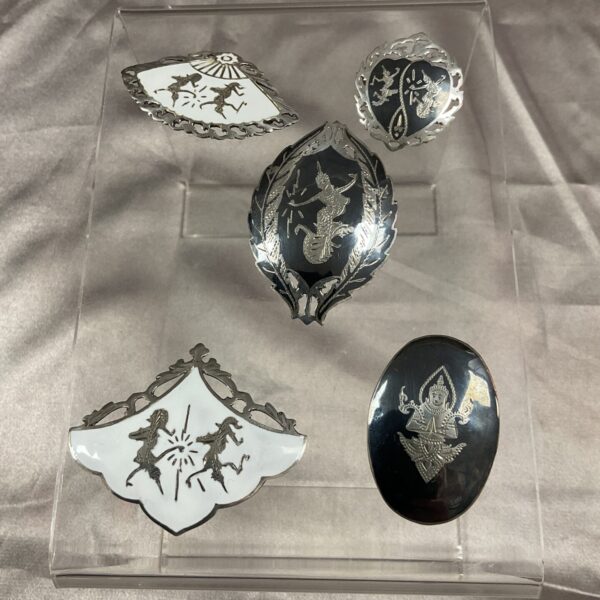 Lot of five vintage Siam enamel brooches with floral designs.