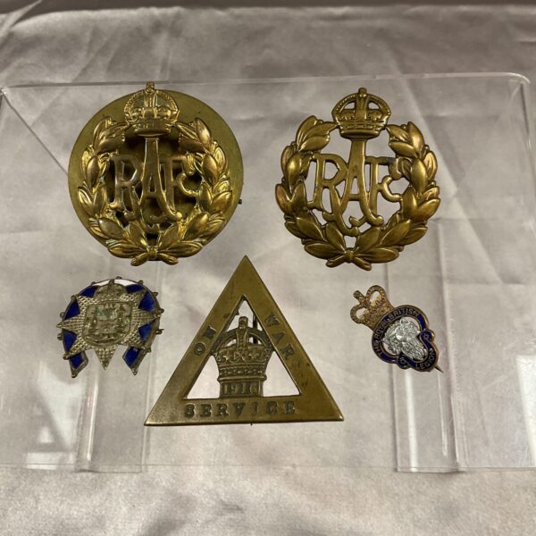 Vintage military badges collection including RAR insignia.