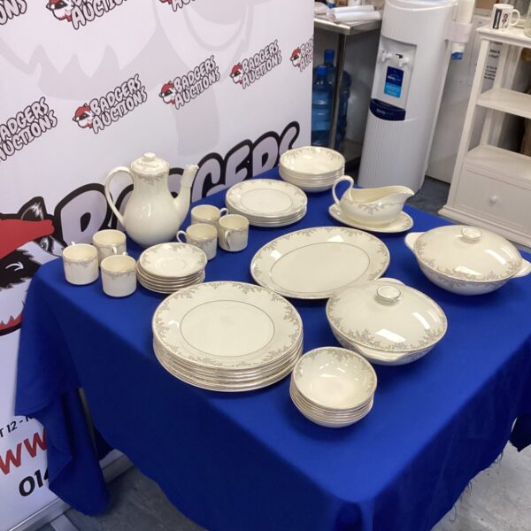 Royal Doulton dinner service set displayed on a blue tablecloth.