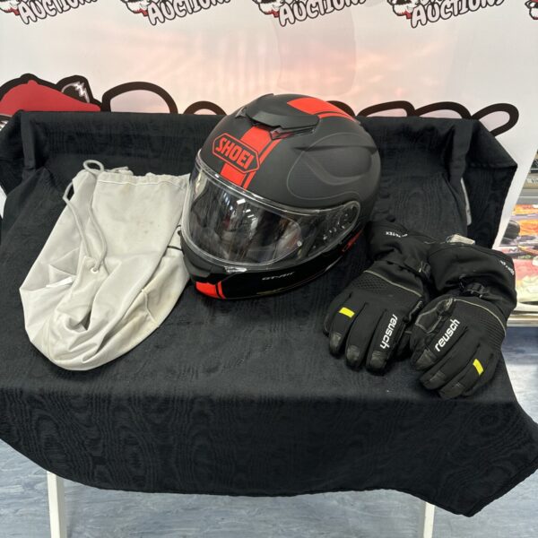 Shoei GT Air motorcycle helmet with Reusch Gore-Tex gloves on display.