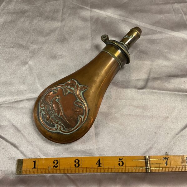 Antique Dixon and Sons copper powder flask with bird detail.