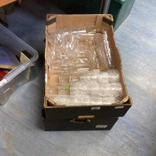 Two boxes of clear plastic party glasses stacked together.