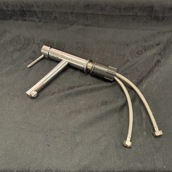 Stainless steel kitchen mixer tap with flexible hoses.
