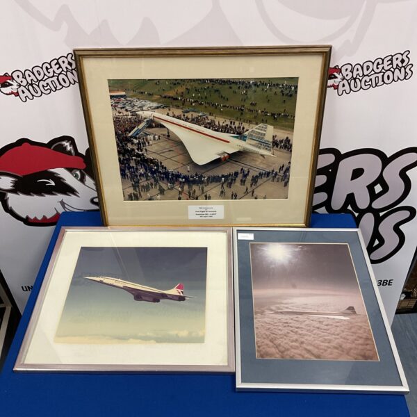 Framed photograph of a Concorde supersonic jet in flight.