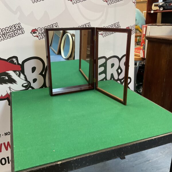 Vintage mirror-backed display cabinet with hinged opening.