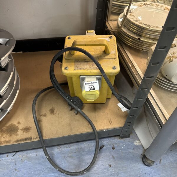 Yellow 110v transformer block with cable, industrial power supply.