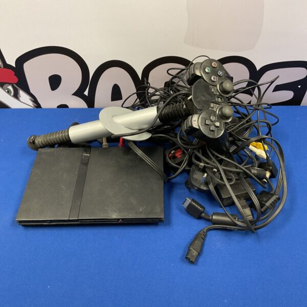 Sony PlayStation 2 slim console with controller and cables.