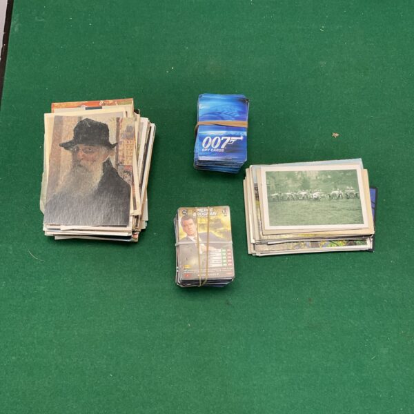 Vintage James Bond trading cards and postcards in a collectible lot.