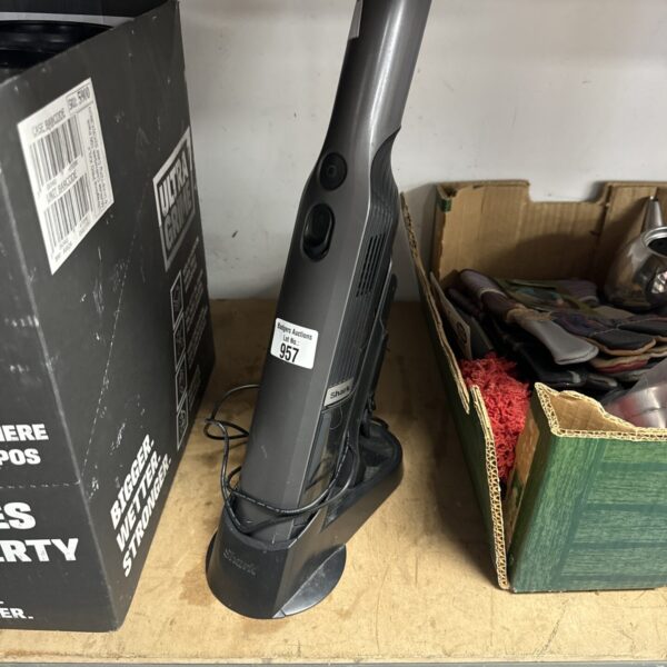 Shark IZ162H handheld vacuum cleaner with charging cradle.