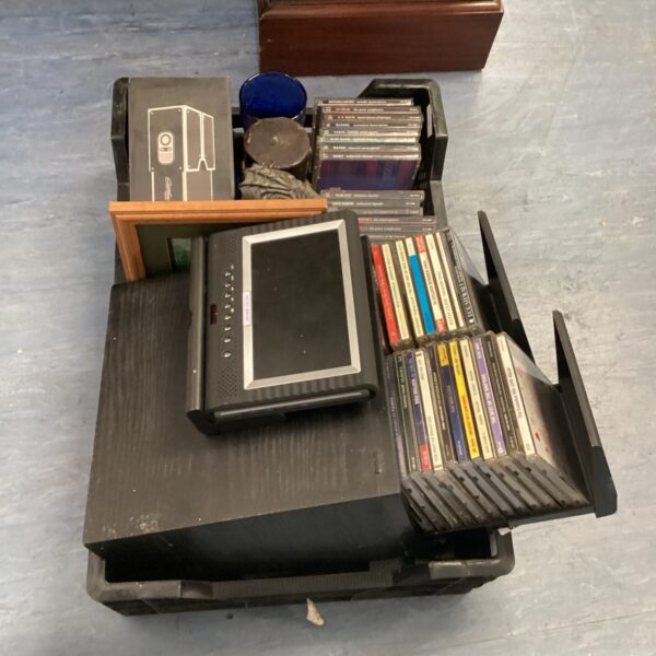 Smartphone projector lot with CDs and candle on a tray.