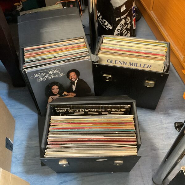 Stacked cases of vintage vinyl records for collectors.