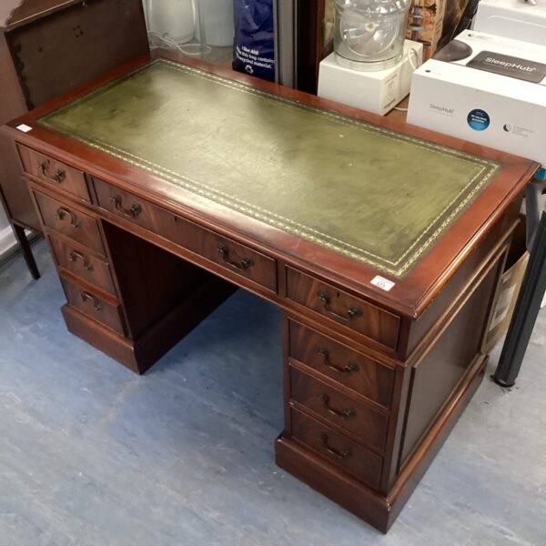 Vintage mahogany executive desk with green leather top.