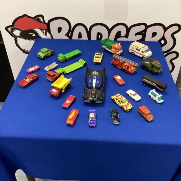 Vintage toy car lot featuring a classic Batmobile and diecast vehicles.
