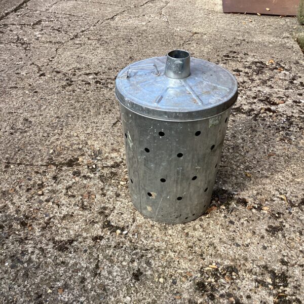 Vintage galvanised garden incinerator with rust patina.