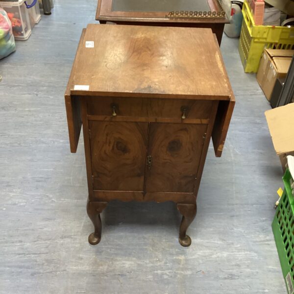 Antique walnut extending cabinet with carved legs and extending top.