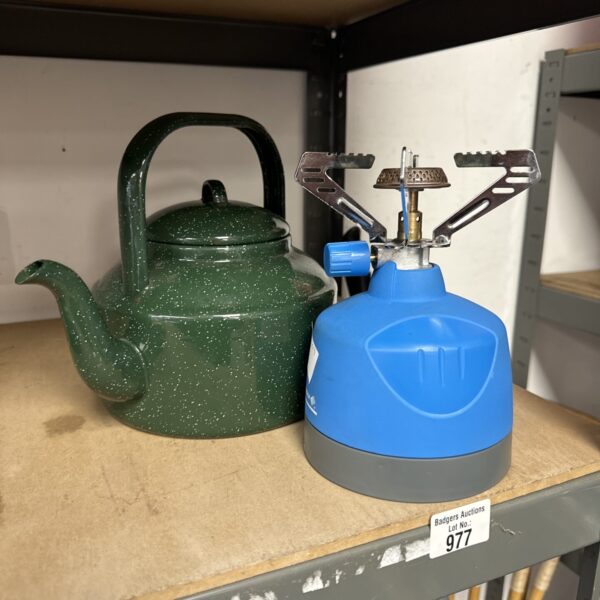 Vintage Camping Gaz stove with green enamel kettle for outdoor cooking.