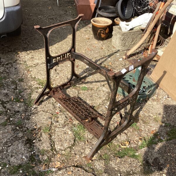 Antique Singer sewing machine base with ornate detailing.