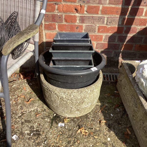 Selection of weathered terracotta garden planters for outdoor use.