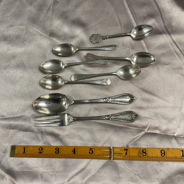 Assorted hallmarked silver forks and spoons, vintage silverware collection.