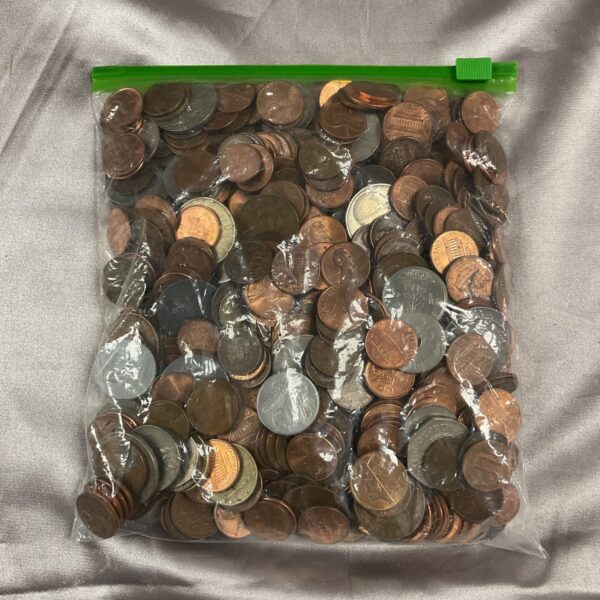 Clear plastic bag filled with a mixed lot of US pennies and coins.