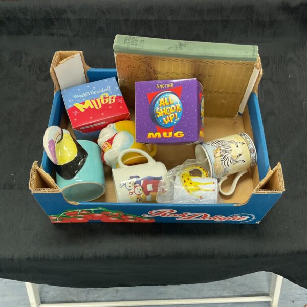 Collection of colourful customised ceramic mugs in a box.