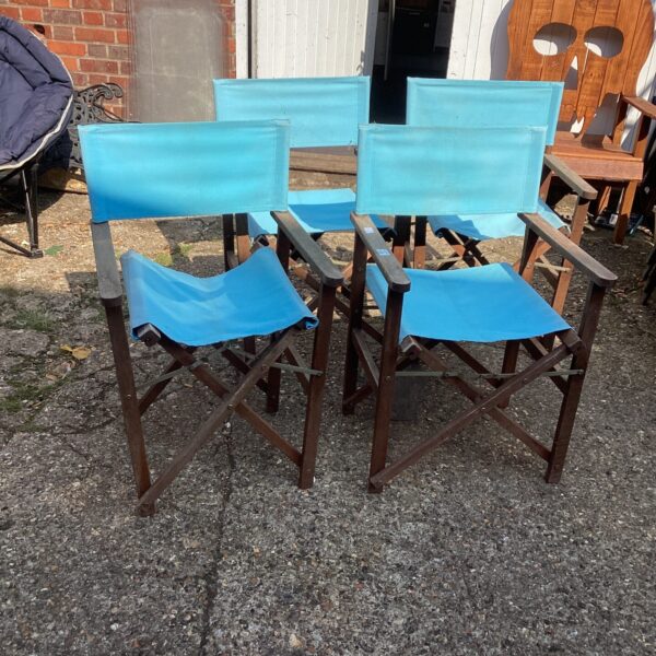 Set of four vintage folding canvas chairs for garden or camping.