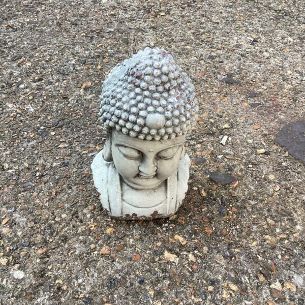 Serene Buddha head ornament for garden or outdoor display.