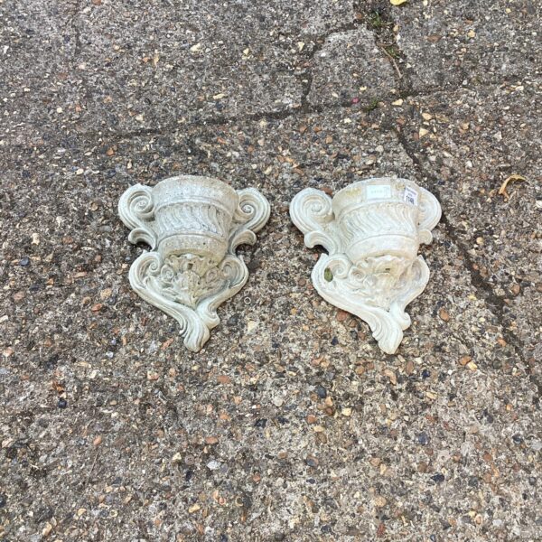 Vintage cherub garden wall planters for trailing plants.
