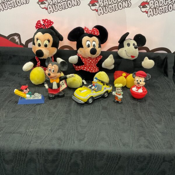 Overview of a Mickey Mouse collection with dolls and figurines.
