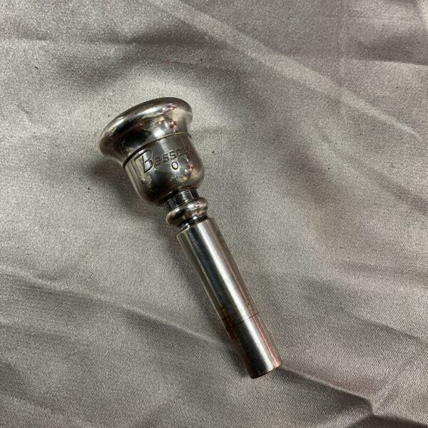 Vintage Besson trumpet mouthpiece in brass, side view.