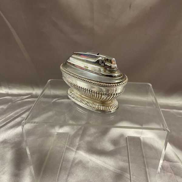 Vintage Ronson Queen Anne silverplate table lighter on display.