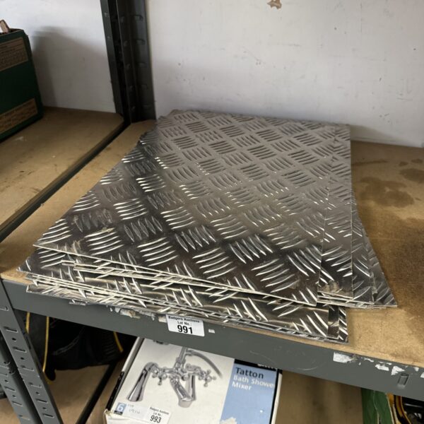 Lot of eleven chequered metal plates for industrial use.