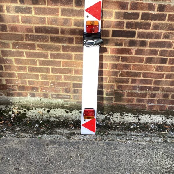 Used trailer lighting board with rear lights for towing.