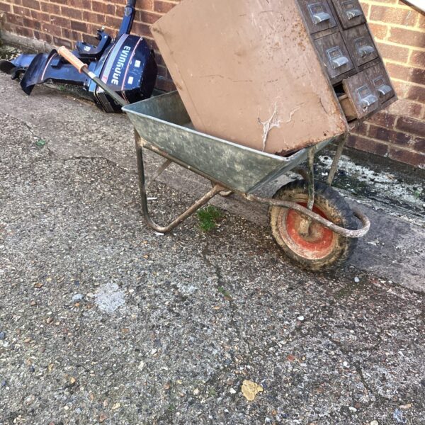 Vintage metal wheelbarrow for garden work and landscaping.