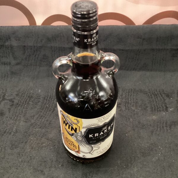 Dark glass bottle of Kraken Black Spiced Rum with kraken label.