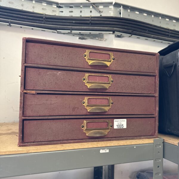 Vintage paperwork cabinet with multiple compartments for document storage.