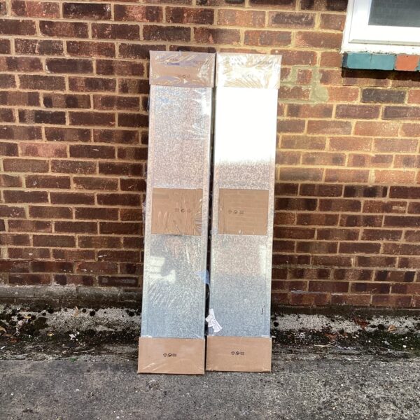 New Ikea metal shelving racks in original packaging for home storage.