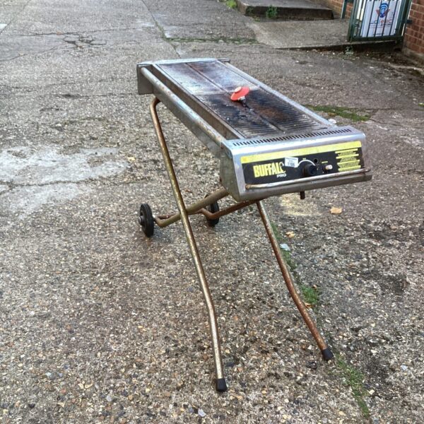 Side view of a used Buffalo Pro gas grill with wheeled frame.