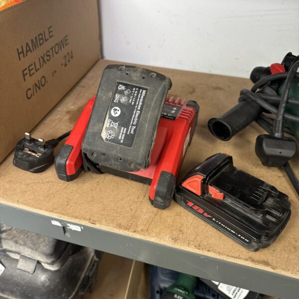 Milwaukee battery charger and two batteries, untested condition.