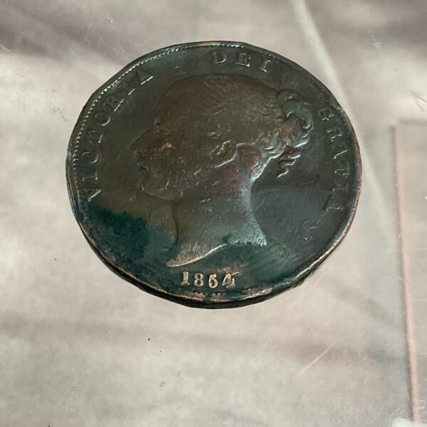 Obverse of an 1864 Victorian Bun Head Penny coin.