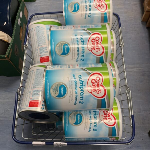 Basket of Cow Gate baby formula containers for infants.