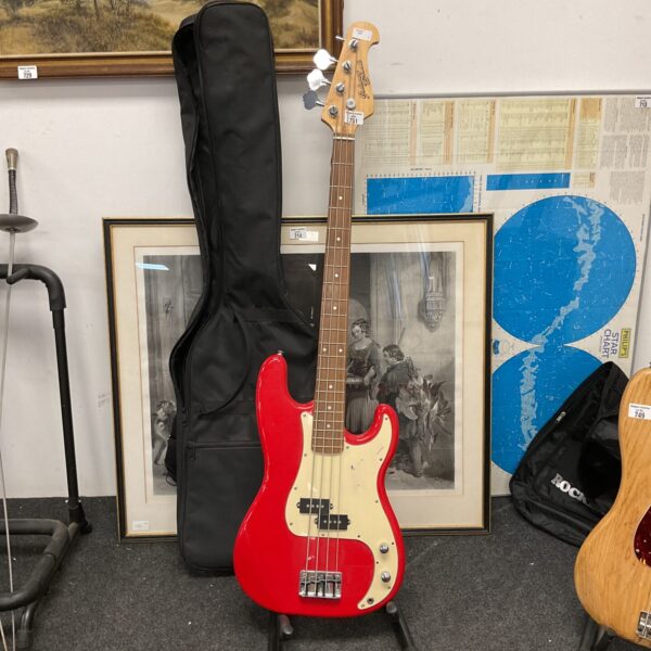 Red Johnny Brook bass guitar with soft case, vintage musical instrument.