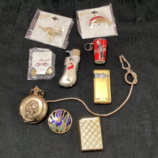 Vintage lighter and brooch lot with Coca-Cola design.