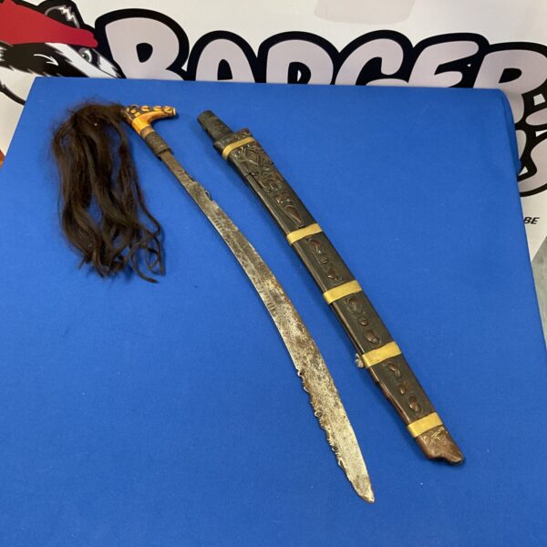 Vintage African tribal sword with carved bone handle.